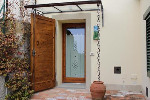 an open door of a house with a vase at Art Apartment Chianti Family in Lappeggi