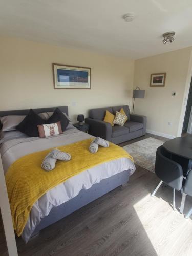 a bedroom with a large bed and a couch at Castle Shieling in Latheron
