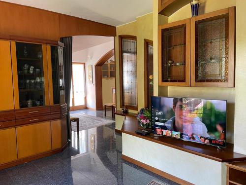 a living room with a flat screen tv on a wall at Relax in Valle D'Aosta da B&G in Aosta