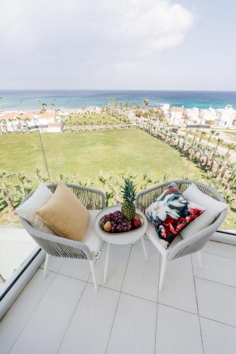 a balcony with a table and chairs and a view of the beach at At Herbal Boutique Hotel & Spa in Protaras