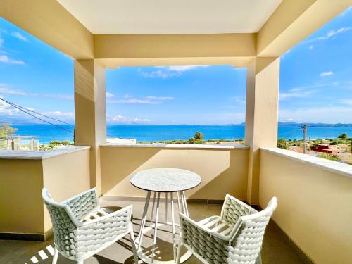a balcony with a table and chairs and a view of the ocean at Luxury Villa Barbati Sun with private pool by DadoVillas in Barbati