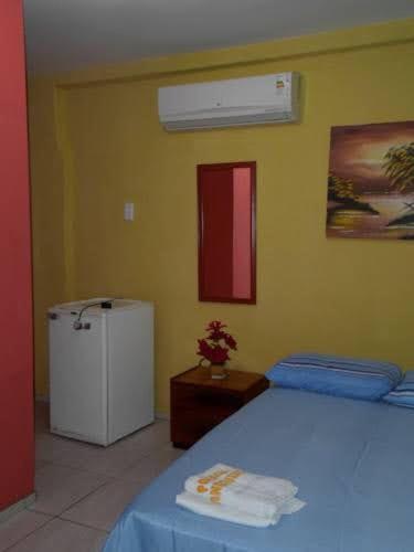 En eller flere senger på et rom på Pousada Só Alegria