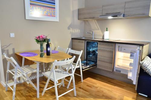 a kitchen with a table and chairs in a room at Apartments Downtown in Zagreb