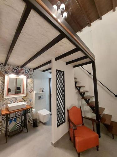 a bathroom with a sink and a desk with a chair at Apartamentos La Florida in Arrecife