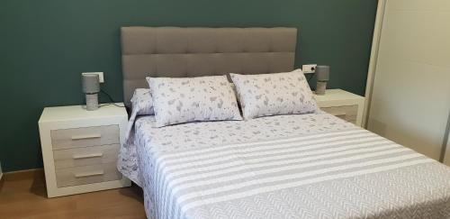 a bedroom with a large bed with two night stands at A Solaina in Lariño