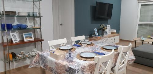 a dining room table with a table cloth and chairs at A Solaina in Lariño