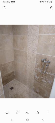 une photo d'une douche avec une douche carrelée dans l'établissement Gite du golf bis, à Gonneville-sur-Mer