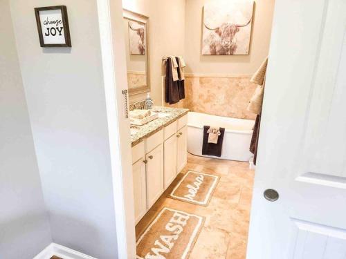 a bathroom with a tub and a sink and a toilet at Canyon Lake Oasis! 3 MIN to Boat Ramp Pet Friendly in Canyon Lake