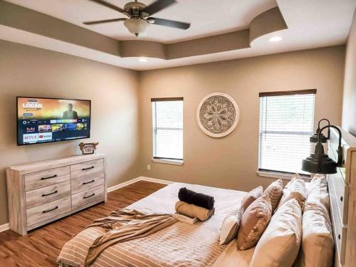 a bedroom with a large bed and a flat screen tv at Canyon Lake Oasis! 3 MIN to Boat Ramp Pet Friendly in Canyon Lake