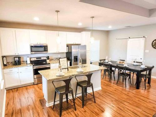 a kitchen with white cabinets and a table with chairs at Canyon Lake Oasis! 3 MIN to Boat Ramp Pet Friendly in Canyon Lake