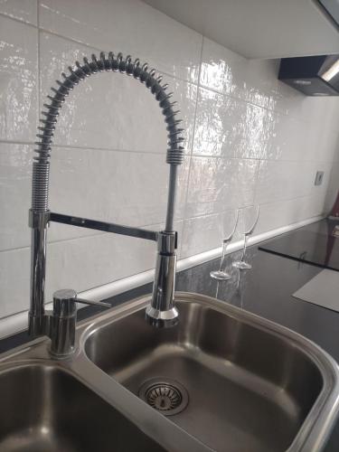 a kitchen sink with a faucet and two wine glasses at VILLA Atlantico Views in Candelaria
