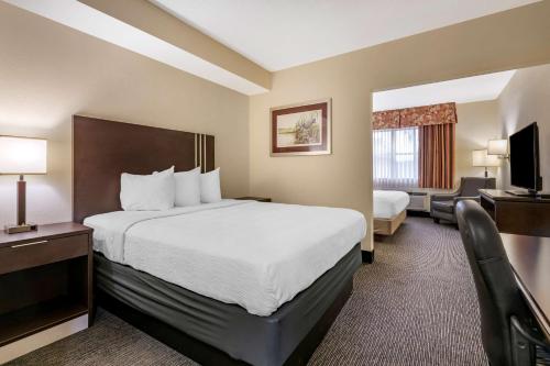 a hotel room with a bed and a desk at Best Western Gateway Grand in Gainesville