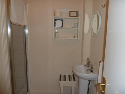 a white bathroom with a sink and a shower at The Owls Crest House B&B in Weston-super-Mare