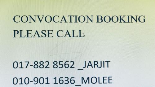 a sign with the words convocation booking please call at Hotel Cahaya in Tanjung Malim