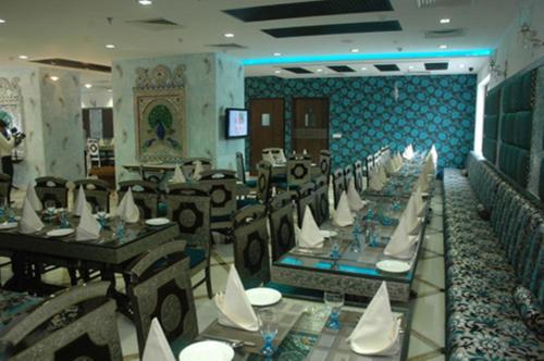 a dining room with tables and chairs in a restaurant at The Ashok, New Delhi in New Delhi