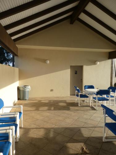 a room with blue and white chairs and tables at Fishermans Landing on The Bay- Las Marinas in South Padre Island