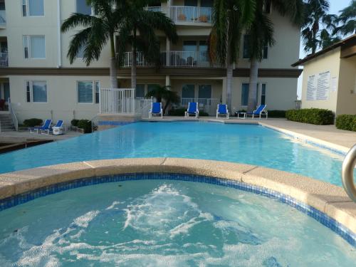 a large swimming pool in front of a building at Fishermans Landing on The Bay- Las Marinas in South Padre Island