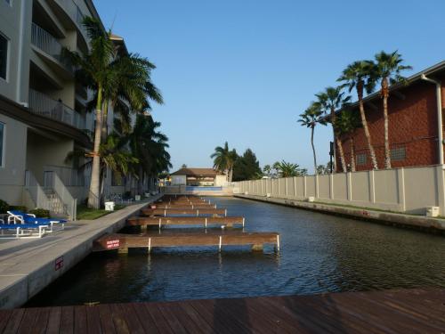 a canal with a row of benches in the water at Fishermans Landing on The Bay- Las Marinas in South Padre Island