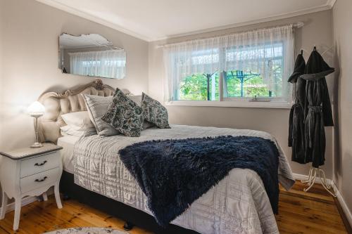 a bedroom with a large bed and a window at Aldgate Valley Bed and Breakfast in Aldgate