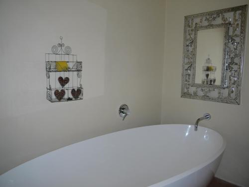 a white bath tub in a bathroom with a mirror at Lookout Darling in Darling