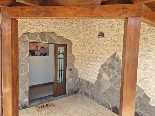 a room with a stone wall and a wooden door at Villa Elisabetta in Pompei