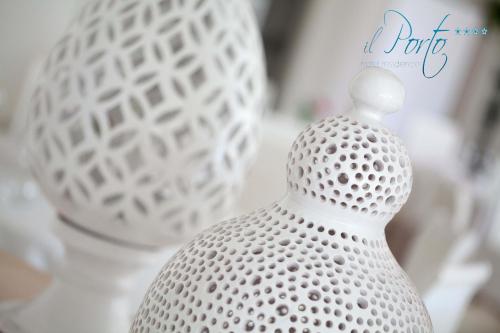 a white vase sitting on top of a table at Hotel Residence Il Porto in Mattinata