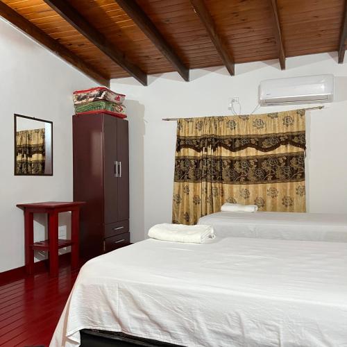 a bedroom with two beds and a window at Adhara Apart in Puerto Iguazú