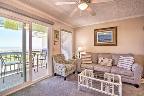 a living room with a couch and a table at Beachfront Isle of Palms Condo with Balcony and Pool! in Isle of Palms