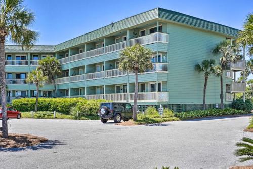 an apartment building with a jeep parked in front of it at Beachfront Isle of Palms Condo with Balcony and Pool! in Isle of Palms