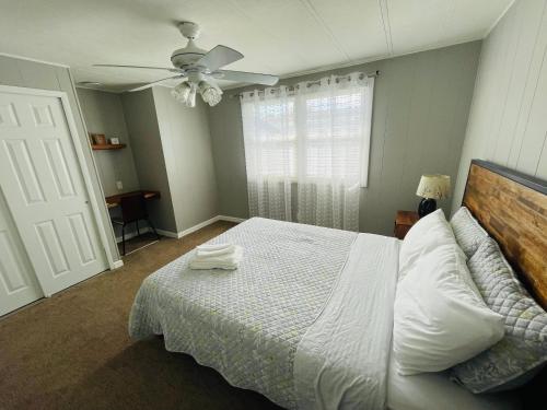 a bedroom with a bed and a ceiling fan at Charming Cottage with Fenced Backyard Pet Friendly in Rehoboth Beach