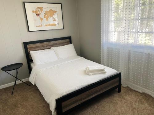 a bedroom with a bed with white sheets and a window at Pet friendly 3 bedroom single family house in Rehoboth Beach