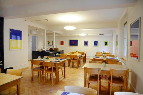 a dining room with wooden tables and chairs at Hotel Marthahaus in Bern