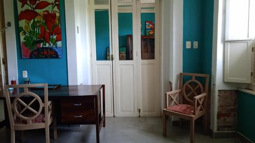 a dining room with blue walls and a table and chairs at Chez Laurel in Rio de Janeiro