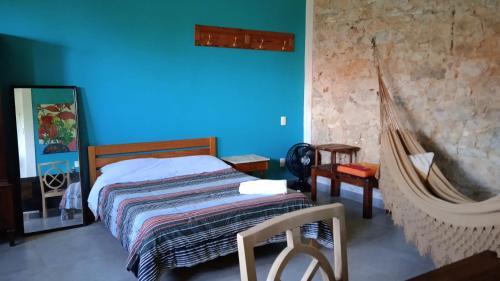 a bedroom with a bed and a blue wall at Chez Laurel in Rio de Janeiro