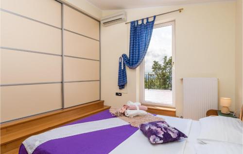 a bedroom with a bed and a large window at Awesome Home In Smrika With Outdoor Swimming Pool in Šmrika