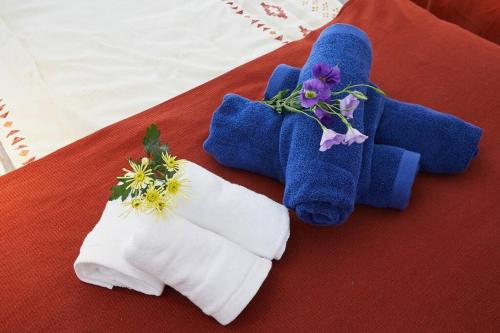 a pair of towels and flowers on a table at G&R House 102 in Tokyo