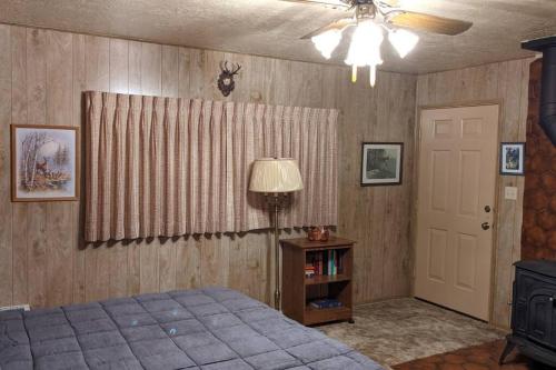 a bedroom with a bed and a ceiling fan at King's Cabin in Wilsonia