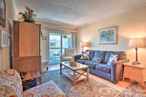 a living room with a couch and a table at Isle of Palms Condo with Pool Access Walk to Beach! in Isle of Palms