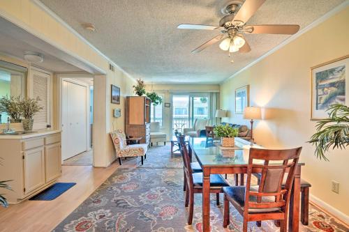 a dining room and living room with a table and chairs at Isle of Palms Condo with Pool Access Walk to Beach! in Isle of Palms