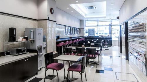 a restaurant with tables and chairs in a cafeteria at Toyoko Inn Kintetsu Nara Ekimae in Nara