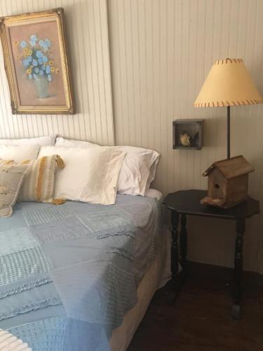 a bedroom with a bed and a table with a lamp at Acorn Hideaways Canton Sweet Tweet Guesthouse King Bed in Canton