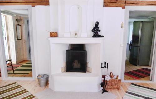 a living room with a fireplace in a house at Holiday Home Nyttorp Högsby in Hultsnäs