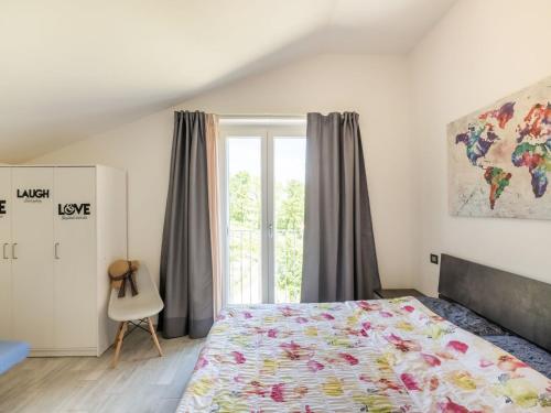 a bedroom with a bed and a window at Rural apartment in Matelica with shared pool in Matelica