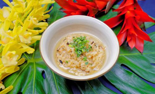 a bowl of rice with chives on top of flowers at Hotel Palm Royal Resort Kokusai Street in Naha