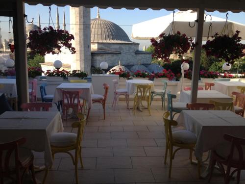 a patio area with tables, chairs and umbrellas at Hotel Sultanahmet in Istanbul