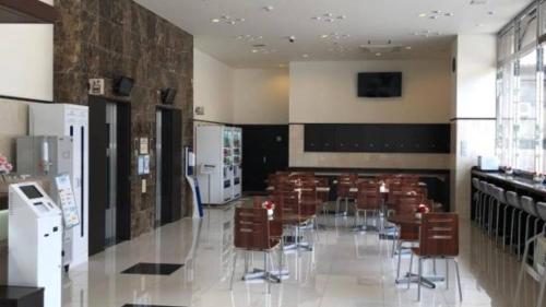 a dining room with tables and chairs in a building at Toyoko Inn Osaka Kadoma-shi Ekimae in Osaka