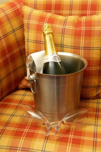 a bottle of champagne in a bucket on a couch at The Pipers' Tryst Hotel in Glasgow