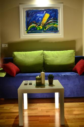a living room with a blue couch and a table at Apartments Downtown in Zagreb