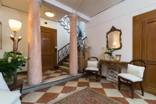 a lobby with columns and a table and chairs at Hotel Relais San Nicolò in Treviso