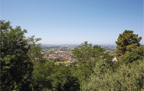a view of a city from behind some trees at Ilsole in Piano di Mommio